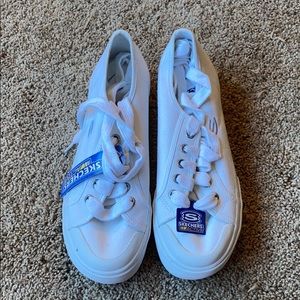 White sketchers tennis shoes